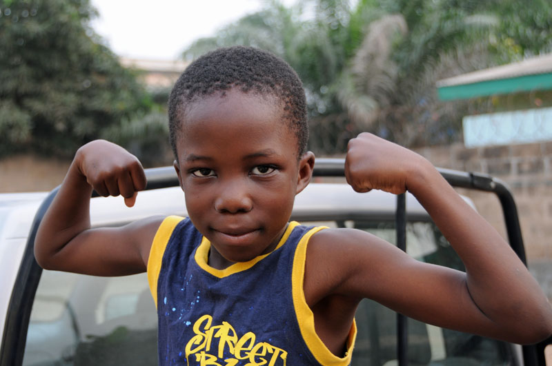 Joseph shows me his muscles