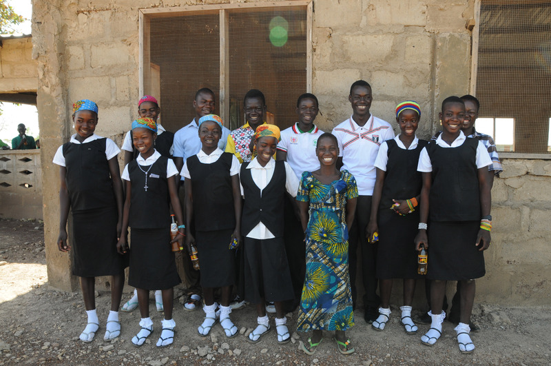The choir posing for a picture outside of the church