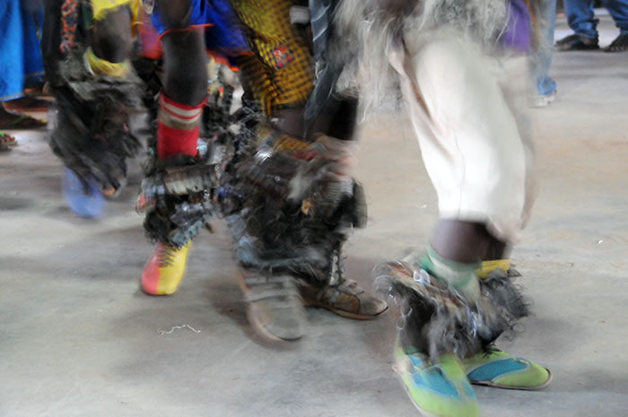 Dancers with metal scrap and rings on their legs dance and shake to the music