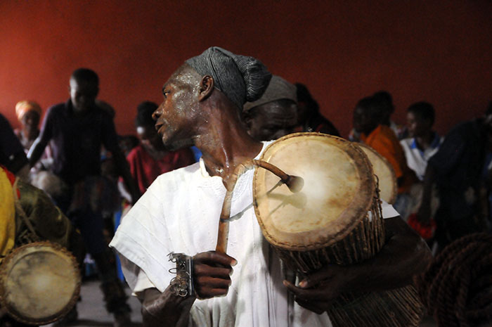The leader plays the "talking" drum